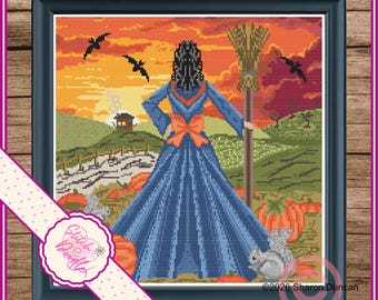 May include: A cross-stitch pattern in a black frame depicting a figure in a long blue dress with an orange bow, holding a broomstick. The scene features a sunset, flying bats, a small house, pumpkins, and a squirrel. Text reads Stitch Doodle.