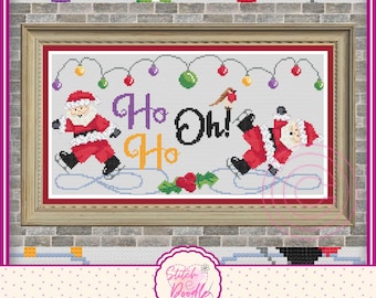 May include: A framed cross-stitch pattern featuring two Santas ice skating on a light gray background. The text reads Ho Ho Oh! in purple, orange, and black. Above are colorful Christmas lights, and a small bird sits on the letter h.