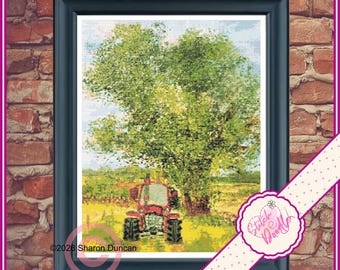 May include: A framed cross-stitch embroidery depicting a red tractor parked in a yellow field beneath a large, leafy green tree. The artwork features a light blue sky and is enclosed in a dark frame. The text 2026 Sharon Duncan is visible.
