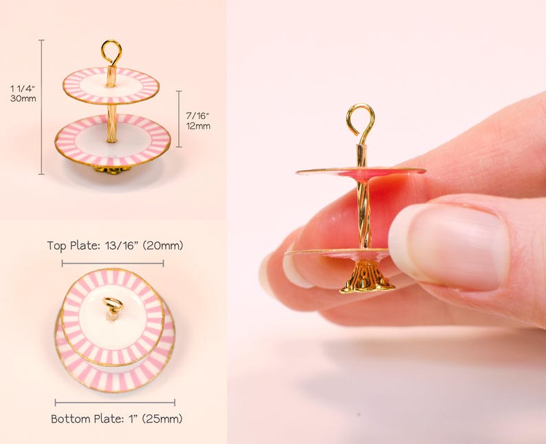 May include: A miniature two-tier cake stand with pink and white striped plates and a gold-tone metal center post. The total height is 1 1/4 inches, with a 7/16 inch tier gap. The top plate is 13/16 inches and the bottom plate is 1 inch wide.