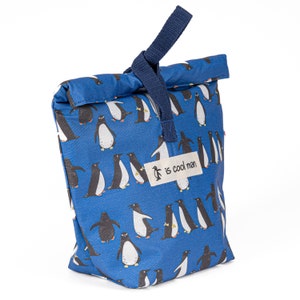 May include: A blue lunch bag with a penguin pattern and a navy blue handle. The bag has a label that says "is cool man" with a penguin logo.