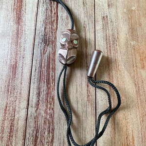 Vintage wood hand crafted mask face with shell eyes bolo-tie