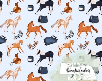 May include: A light blue background features a repeating pattern of horses in various colors, along with saddles, saddle pads, and other equestrian equipment. The horses are depicted in shades of brown, white, and black. The design includes the text "Nebraskan Creations".