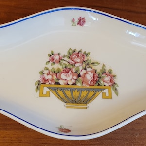 Vintage dish decorated with a basket, roses and blue border. 23 x 12.5 cm. 1930.