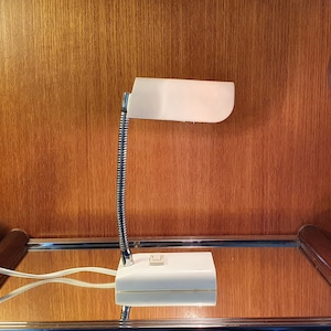 Bedside or desk lamp in plastic and adjustable metal rod. Made in France 1970.