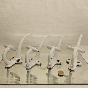Set of 4 vintage enameled metal coat hooks. Made in France. 1930s. Enameled coat rack.