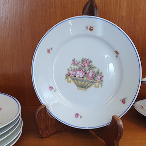 Set of 6 vintage porcelain dessert plates with flower decorations, basket and blue border. Made in France 1930.