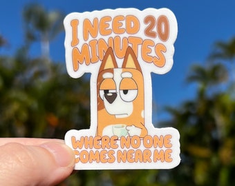May include: A sticker featuring a cartoon dog with a cup of coffee, with the text "I need 20 minutes where no one comes near me".