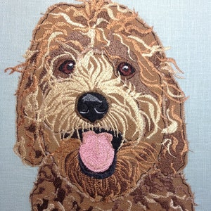May include: Embroidered image of a brown and white dog with its tongue sticking out. The dog has a happy expression and is looking directly at the viewer.