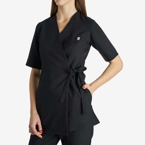 May include: Black wrap-style top with short sleeves and a tie at the waist.
