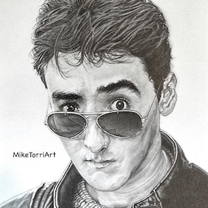 May include: A detailed pencil drawing of a person wearing aviator sunglasses. The drawing is in black and white, with the artist's signature "Mike TorriArt" in the lower left corner. The person is wearing a leather jacket and a sweater.