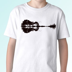 May include: White t-shirt with a black silhouette of a guitar made of trees and their reflection in water.