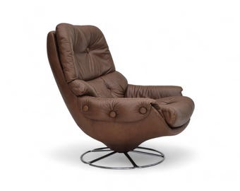 May include: A brown leather swivel chair with a tufted back and seat. The chair has a round base with a chrome finish.