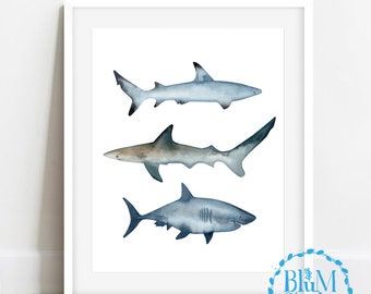 May include: Watercolor painting of three sharks in shades of blue and gray on a white background. The sharks are arranged vertically, with the largest shark at the bottom and the smallest shark at the top.