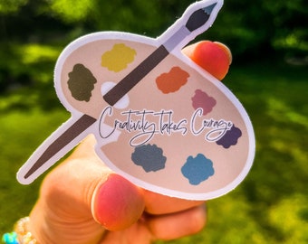 May include: A sticker with a paint palette and paintbrush, with the text "Creativity Takes Courage" in cursive.