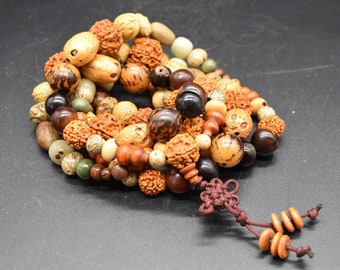 May include: A multi-strand beaded necklace with brown, beige, and green beads. The necklace has a brown tassel with a knot at the end.