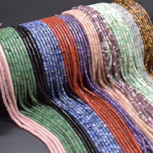 May include: Assortment of gemstone beads in various colors, including green, blue, red, purple, and pink. The beads are arranged in rows, creating a colorful and textured pattern.