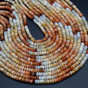May include: A strand of multi-coloured opal beads. The beads are small and round, and they are arranged in a loose, flowing pattern. The colours of the beads range from white to orange to brown.