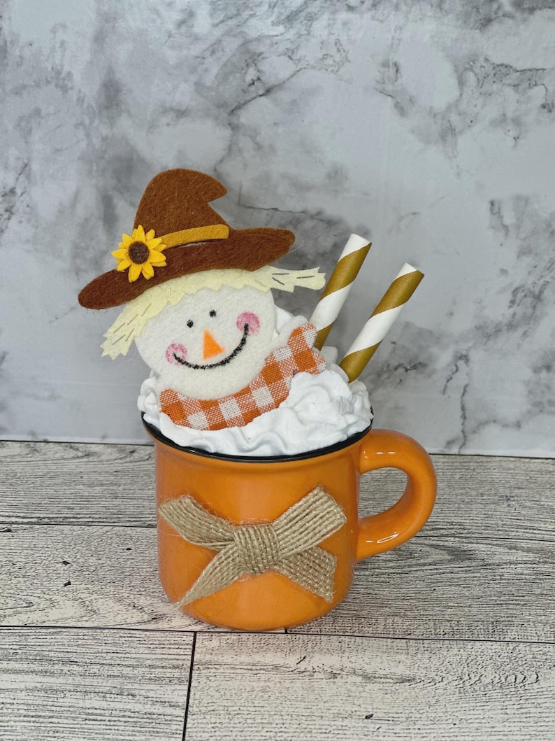 May include: A set of three ceramic mugs with a speckled, matte finish. The mugs are in shades of cream, light gray, and dark gray. Each mug has a simple, minimalist design, perfect for coffee or tea.