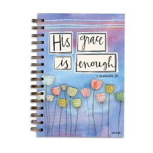 May include: A blue spiral bound journal with a watercolor background and a quote that reads "His grace is enough" with the scripture reference "2 Corinthians 12:9". The journal is decorated with colorful flowers.