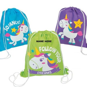 May include: Three drawstring bags with unicorn designs. One bag is blue with the text "So Fancy!" and stars. Another bag is green with the text "Follow Your Dreams" and stars. The third bag is purple with a yellow star.