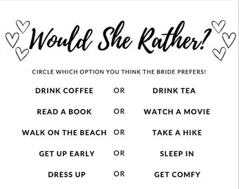 May include: A white bridal shower game card with the text "Would She Rather?" in a script font. The game includes options like "Drink Coffee or Drink Tea" and "Shop Online or Shop in Store."