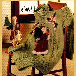 May include: A green knitted jumper with a Santa Claus and Christmas tree design. The jumper has a turtleneck and is sitting on a wooden chair.