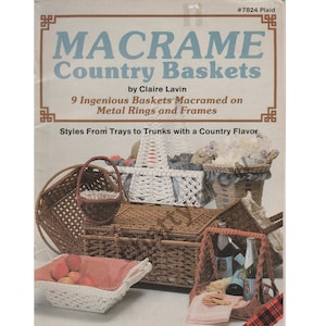 May include: A book cover with the title "Macrame Country Baskets" by Claire Lavin. The cover features a variety of macrame baskets in different shapes and sizes, including a picnic basket, a small round basket, and a rectangular basket. The book cover also includes the text "9 Ingenious Baskets Macramed on Metal Rings and Frames" and "Styles From Trays to Trunks with a Country Flavor."