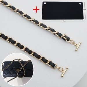 May include: A gold-tone metal chain strap interwoven with black leather, featuring toggle bar ends. Includes a black rectangular plate measuring 17 cm by 8 cm and a small inset showing a black quilted handbag with the same chain strap attached.