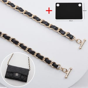 May include: Black and gold chain strap with a small black purse in a circle. The chain is made of gold links with black leather woven through. A black rectangle is shown with measurements of 8.5 cm by 5.4 cm.