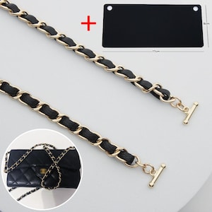 May include: Black and gold chain strap with a black leather insert. The strap is shown with a black rectangular piece that is 17cm long and 8cm wide. A small black quilted handbag with a gold chain is also shown.