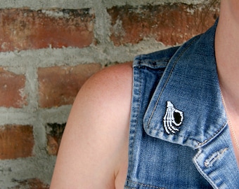 Skeleton Hand Enamel Pin