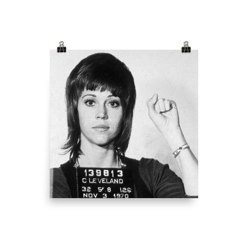 May include: Black and white mugshot photo of a woman with short, dark hair. The photo includes the text "139813", "CLEVELAND", "32 5 8 126", and "NOV 3 1970".