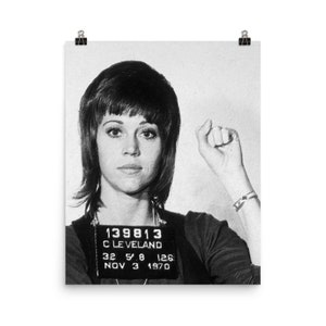 May include: Black and white mugshot photo of a woman with short, dark hair. She is wearing a dark shirt and has a name tag that reads "139813 CLEVELAND 32 5'8 126 NOV 3 1970".