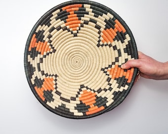 Earthy Woven Sisal Basket: Orange & Charcoal Flower Pattern, Ugandan Decor. hanging wall decor