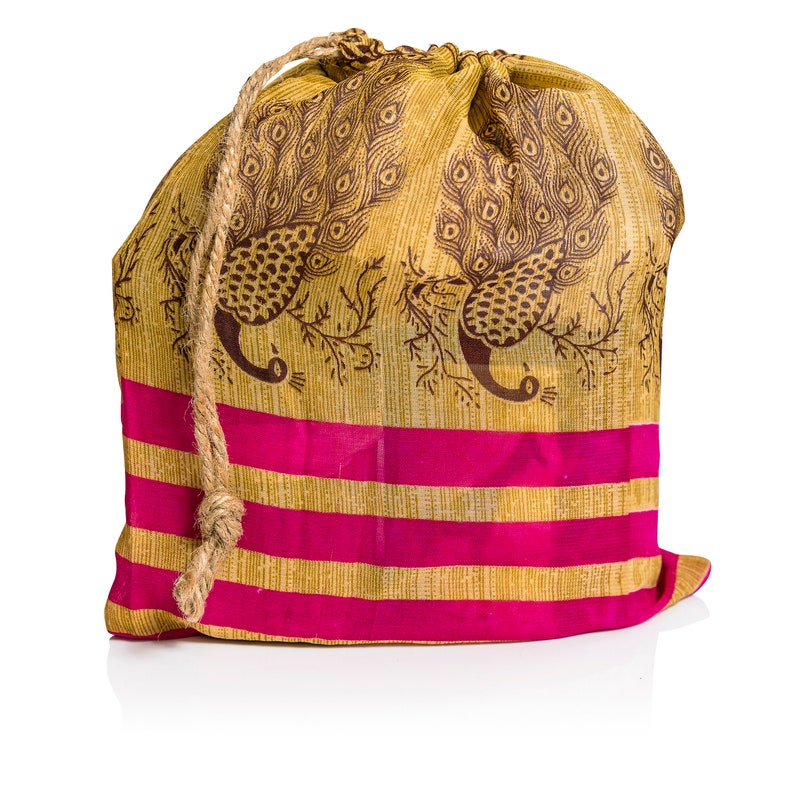 May include: A drawstring bag made of fabric with a peacock design in brown and gold. The bag has pink and gold stripes and a brown rope drawstring.