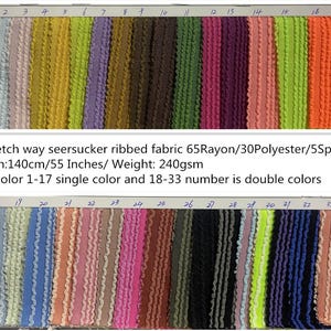 May include: A fabric sample card featuring a variety of seersucker ribbed fabric swatches in multiple colors. The fabric is 140cm (55 inches) wide and weighs 240gsm. Colors range from light blue to orange, with some double-color options.