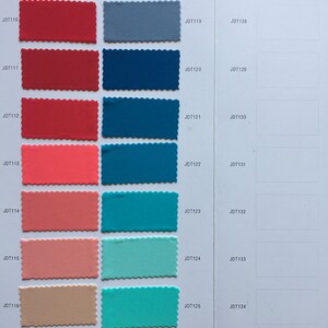 May include: A color chart with fabric swatches in various shades of red, blue, green, and orange. The swatches are labeled with numbers, such as JDT109, JDT110, JDT111, and so on.