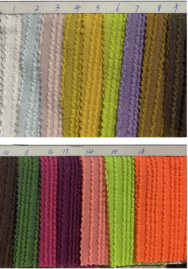 May include: A collection of sixteen fabric swatches in various colors, including white, blue, pink, yellow, green, purple, brown, and orange. Each swatch has a textured, ribbed design. The swatches are numbered 1 through 16.