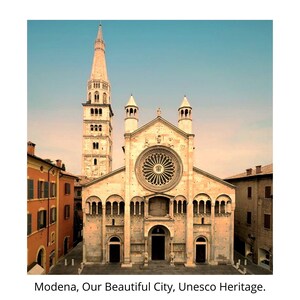 May include: A large, beige cathedral with a tall, pointed tower. The cathedral has a large, round window with intricate stained glass. The building is surrounded by a cobblestone plaza.