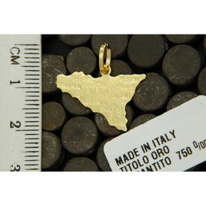 Sicily pendant next to a ruler to understand its dimensions.