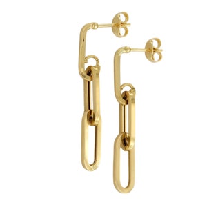 May include: Gold chain link earrings with a long, dangling design. The earrings are made of multiple oval-shaped links.