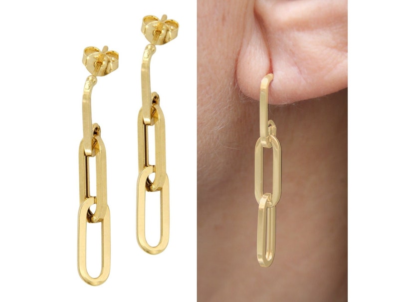 May include: Gold chain link earrings with a simple design. The earrings are made of three connected oval links.
