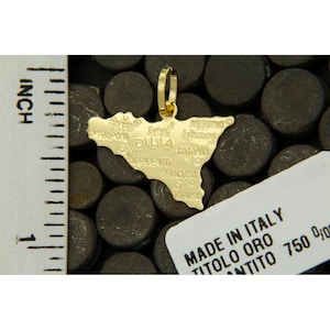 Sicily pendant next to a ruler to understand its dimensions.
