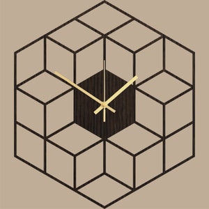 May include: A geometric wall clock with a dark wood face and gold-colored hands. The clock is shaped like a cube and has a 3D effect.