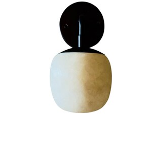 May include: A set of three ceramic mugs with a speckled, matte finish. The mugs are in shades of cream, light gray, and dark gray. Each mug has a simple, minimalist design, perfect for coffee or tea.