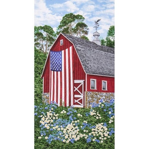 May include: A red barn with a large American flag hanging from the side. The barn has a stone foundation and a weathervane on top. There are blue and white flowers in the foreground.