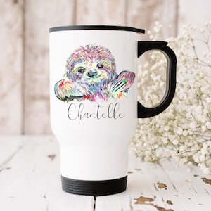 May include: White travel mug featuring a colourful sloth illustration and the name "Chantelle" printed on the front.