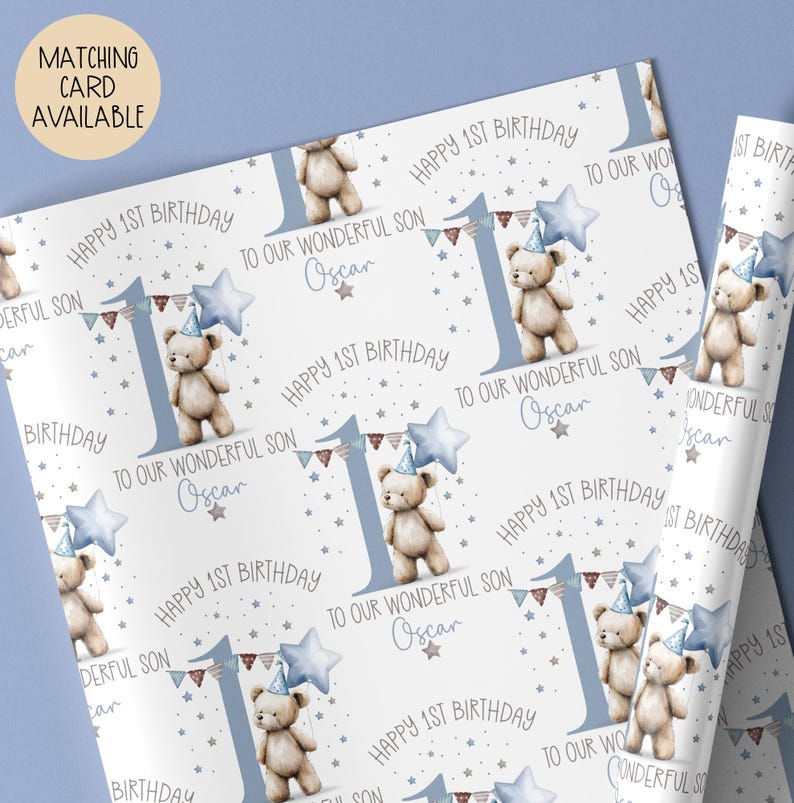 Luxury white personalised 1st birthday wrapping paper, featuring a gorgeous teddy holding a blue star balloon standing next to a blue number 2 & matching bunting surrounded by little stars & the wording 'Happy 1st Birthday to our wonderful Son/Grandson/Nephew, any relation' personalised with the child's name.