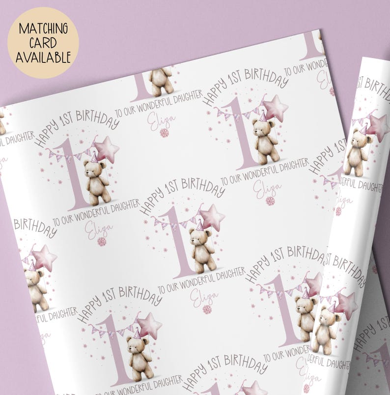 Luxury white personalised 1st birthday wrapping paper, featuring a gorgeous teddy holding a pink star balloon standing next to a blue number 1 & matching bunting surrounded by little flowers & the wording 'Happy 1st Birthday to our wonderful Daughter, Granddaughter, Niece, any relation' personalised with the child's name.
